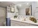 Well lit bathroom featuring a tub with shower, and a vanity with white countertop and cabinets at 7665 E Eastman Ave # 210, Denver, CO 80231