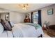 This serene bedroom offers a comfortable bed, neutral colors, and natural light from the window at 7665 E Eastman Ave # 210, Denver, CO 80231