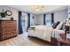 Comfortable bedroom features neutral carpet, ceiling fan, and a large window at 7665 E Eastman Ave # 210, Denver, CO 80231