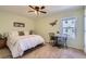 This bedroom offers neutral tones, a ceiling fan, natural light, and a cozy atmosphere at 7665 E Eastman Ave # 210, Denver, CO 80231