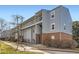 Exterior view of a well-maintained apartment building with brick accents and mature landscaping, offering an inviting curb appeal at 7665 E Eastman Ave # 210, Denver, CO 80231