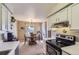 Kitchen featuring appliances and a dining area nearby at 7665 E Eastman Ave # 210, Denver, CO 80231