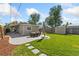 Expansive backyard with a stone paver patio and a well-maintained lawn and play area at 1253 Uinta St, Denver, CO 80220