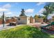 Wide backyard featuring seating area, storage shed, play area, and privacy fence at 1253 Uinta St, Denver, CO 80220