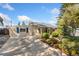 Charming home with a well-manicured front yard, a spacious driveway, and inviting curb appeal at 1253 Uinta St, Denver, CO 80220