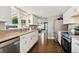 Bright kitchen features stainless steel appliances, granite counters, ample cabinetry and a window over the sink at 1253 Uinta St, Denver, CO 80220
