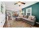 Comfortable living room with a large sectional sofa, colorful accent wall, and open access to the dining area at 1253 Uinta St, Denver, CO 80220