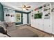Cozy living room featuring custom built-ins, a decorative ceiling fan, and comfortable seating at 1253 Uinta St, Denver, CO 80220
