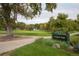 A view of Verbena Park featuring a sign, mature trees, playground, and greenery at 1253 Uinta St, Denver, CO 80220