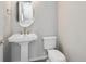 Bathroom featuring pedestal sink, oval mirror, and standard toilet at 3654 Penang Dr, Castle Rock, CO 80109