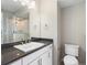 A bathroom featuring a toilet, a sink, chrome fixtures, white cabinets and countertop, and a glass enclosed shower at 3654 Penang Dr, Castle Rock, CO 80109