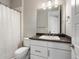 A bathroom featuring a vanity, toilet, mirror, chrome fixtures, and a shower with curtain at 3654 Penang Dr, Castle Rock, CO 80109