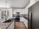 Contemporary kitchen features stainless steel appliances, gray counters, a large island, and bright white cabinetry at 3654 Penang Dr, Castle Rock, CO 80109