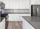 Well-lit kitchen showcases stainless steel appliances, gray countertops, and modern white cabinets at 3654 Penang Dr, Castle Rock, CO 80109