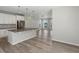Open-concept kitchen featuring a large island with modern pendant lighting and stainless steel appliances at 3654 Penang Dr, Castle Rock, CO 80109