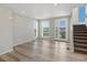 Bright living room with wood floors, ample windows, and staircase at 3654 Penang Dr, Castle Rock, CO 80109