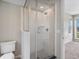 A glass enclosed shower with white subway tile and chrome fixtures, adjacent to a toilet in the bathroom at 3654 Penang Dr, Castle Rock, CO 80109