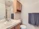Well-lit bathroom with vanity, mirror, shower, and convenient storage at 453 S Quay Street, Lakewood, CO 80226
