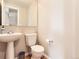 Bright half bath with pedestal sink, neutral paint and wood look flooring at 453 S Quay Street, Lakewood, CO 80226