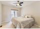 Bedroom featuring a ceiling fan and sliding door access to a private balcony at 453 S Quay Street, Lakewood, CO 80226