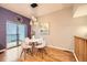 Cozy dining area features modern lighting, an adjacent balcony, and hardwood flooring at 453 S Quay Street, Lakewood, CO 80226