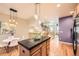 Open concept kitchen features a center island with black countertops and hardwood flooring at 453 S Quay Street, Lakewood, CO 80226