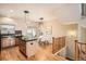 Kitchen with central island with a black countertop, wooden cabinets, and a dining table with a stairwell nearby at 453 S Quay Street, Lakewood, CO 80226
