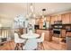 Bright kitchen and dining area with hardwood floors, stainless steel appliances, and modern lighting fixtures at 453 S Quay Street, Lakewood, CO 80226