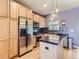 Modern kitchen with stainless steel appliances, black countertops, and light wood cabinetry at 453 S Quay Street, Lakewood, CO 80226