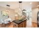 Bright kitchen with center island, hardwood floors, stainless steel appliances, and access to the stairs at 453 S Quay Street, Lakewood, CO 80226