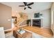 Open-concept living room with fireplace and hardwood floors, flowing into the dining area at 453 S Quay Street, Lakewood, CO 80226