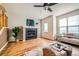 Living room with hardwood floors, a fireplace, a ceiling fan, and a cozy sitting area near a window at 453 S Quay Street, Lakewood, CO 80226