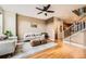 Bright living room with hardwood floors, comfortable seating, modern decor, and a staircase to the next floor at 453 S Quay Street, Lakewood, CO 80226
