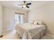 Inviting bedroom with ceiling fan, plush bed and access to a private balcony at 453 S Quay Street, Lakewood, CO 80226
