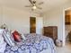 Comfortable bedroom with ceiling fan, chest of drawers, and ensuite bathroom at 453 S Quay Street, Lakewood, CO 80226