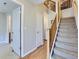 Bright foyer features a carpeted staircase with wood railing and access to the home's various rooms at 453 S Quay Street, Lakewood, CO 80226