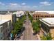 Aerial view of the city street with trees lining the road, surrounding buildings, and mountains in the distance at 453 S Quay Street, Lakewood, CO 80226