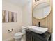 Stylish powder room featuring modern vessel sink and elegant oval mirror at 671 Robert St, Longmont, CO 80503