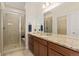 Bathroom with a granite countertop vanity and walk-in tiled shower at 671 Robert St, Longmont, CO 80503