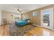 Bright bedroom showcasing unique accent wall, hardwood floors, and access to the balcony at 671 Robert St, Longmont, CO 80503