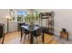 Cozy dining area with modern table set, hardwood flooring, and ample natural light at 671 Robert St, Longmont, CO 80503