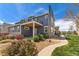 Charming two-story home with blue siding, stone accents, and a landscaped front yard at 671 Robert St, Longmont, CO 80503