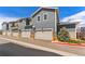Newer townhomes featuring individual garages, siding, and stone accents at 671 Robert St, Longmont, CO 80503