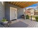 Inviting front porch with outdoor seating and a grill at 671 Robert St, Longmont, CO 80503