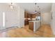 Modern kitchen with a central island, stainless steel appliances, and wood cabinetry at 671 Robert St, Longmont, CO 80503