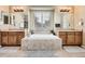Elegant bathroom with dual vanities, a soaking tub, and large mirrors for a spa-like experience at 12185 S Grass River Trl, Parker, CO 80134