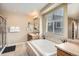Relaxing bathroom featuring a soaking tub, tiled surround, and a separate glass-enclosed shower at 12185 S Grass River Trl, Parker, CO 80134