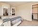 Neutral bedroom features a comfortable bed and access to a closet and bathroom at 12185 S Grass River Trl, Parker, CO 80134