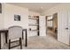 Neutral office room features shelving and access to other areas of the home at 12185 S Grass River Trl, Parker, CO 80134
