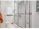 Bright bathroom featuring a glass-enclosed shower and white tiled walls at 434 N Washington St, Denver, CO 80203